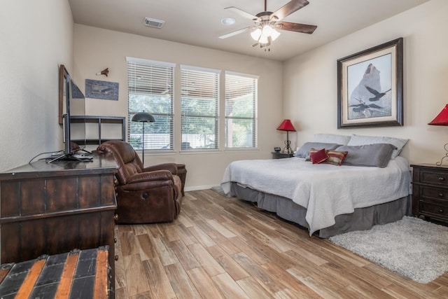 bedroom with ceiling fan and light wood-type flooring