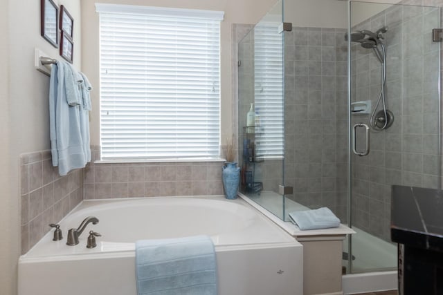 bathroom featuring separate shower and tub