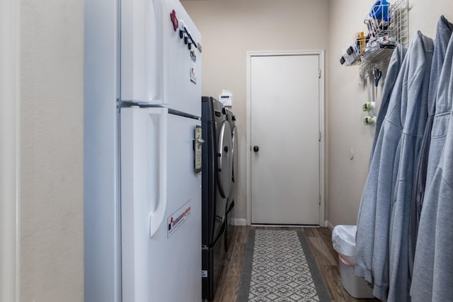 laundry area featuring washing machine and dryer and dark hardwood / wood-style floors