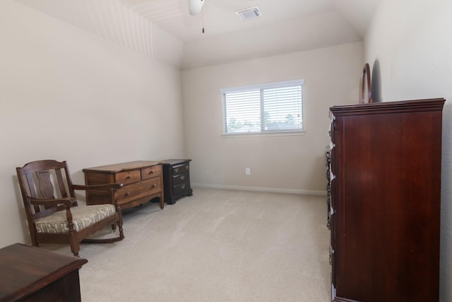 living area featuring light colored carpet, ceiling fan, and lofted ceiling