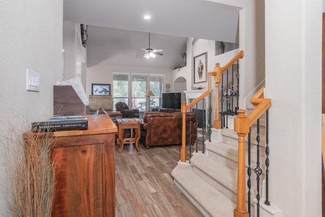 office space featuring ceiling fan, light hardwood / wood-style floors, and lofted ceiling