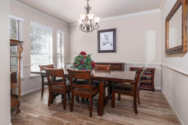 dining area with crown molding, a wealth of natural light, and a chandelier