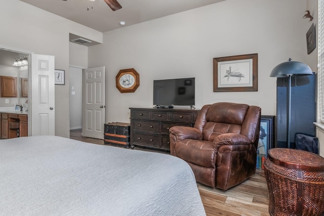 bedroom featuring ensuite bathroom, ceiling fan, light hardwood / wood-style floors, and sink