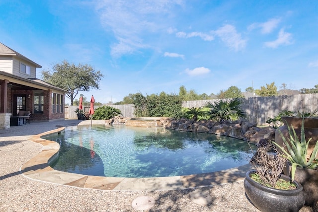 view of pool featuring a patio area and an in ground hot tub