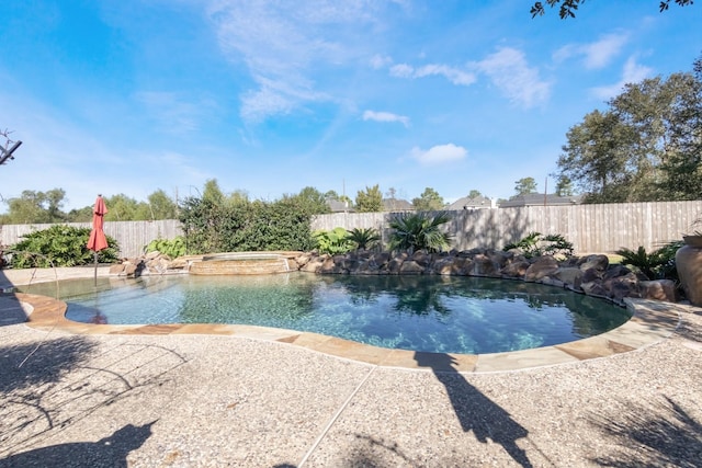 view of pool with a patio area and an in ground hot tub