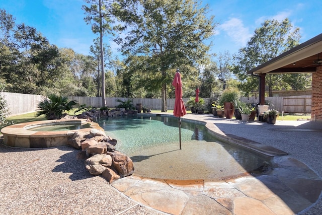 view of pool with an in ground hot tub and a patio