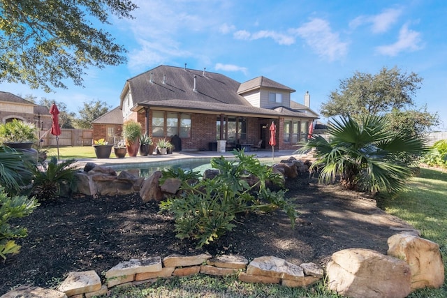 back of house with a patio