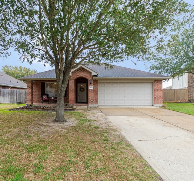 ranch-style home with a garage and a front lawn