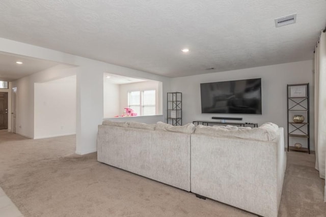 living room with light colored carpet and a textured ceiling