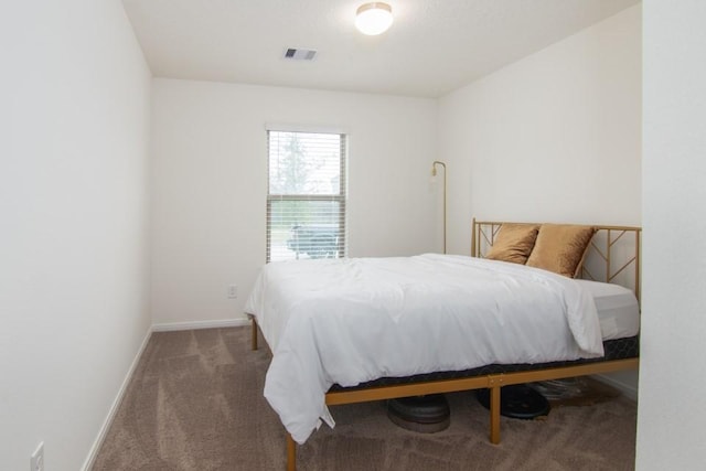 bedroom featuring dark colored carpet