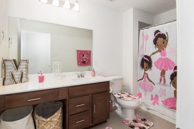 bathroom featuring vanity, tile patterned floors, a shower with shower curtain, toilet, and a textured ceiling