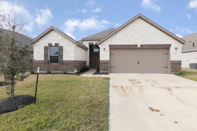 view of front of property with a garage and a front lawn