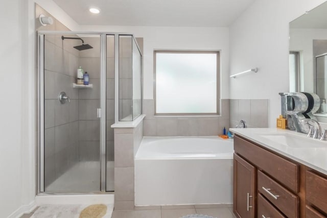 bathroom with separate shower and tub, tile patterned floors, and vanity