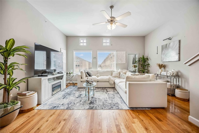 living room featuring light hardwood / wood-style flooring and ceiling fan