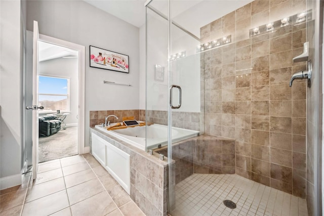 bathroom featuring tile patterned flooring and separate shower and tub