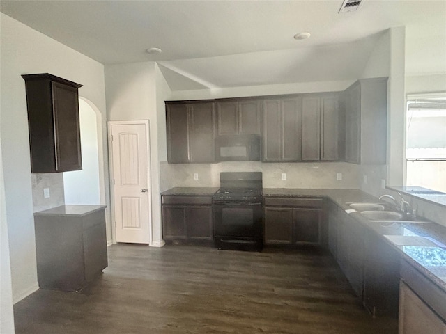 kitchen featuring dark hardwood / wood-style floors, dark brown cabinetry, sink, and black electric range