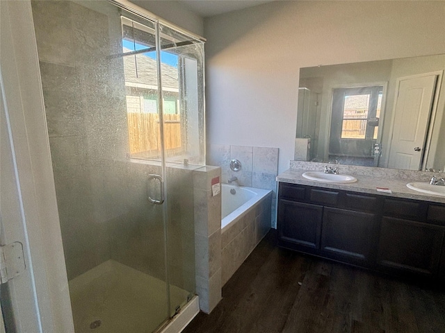 bathroom with vanity, wood-type flooring, and independent shower and bath