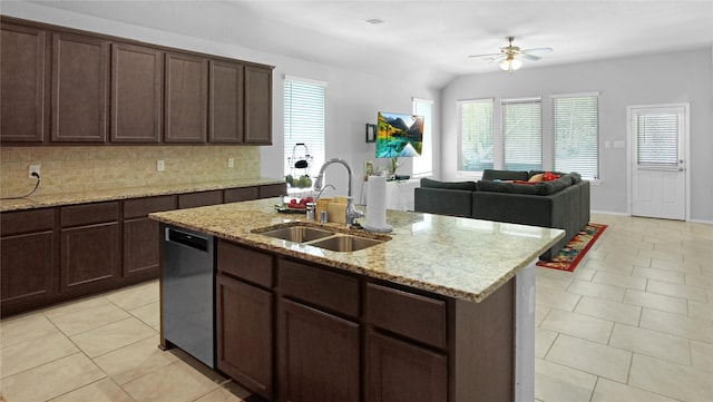 kitchen featuring ceiling fan, dishwasher, sink, vaulted ceiling, and a center island with sink