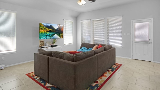 tiled living room featuring ceiling fan and vaulted ceiling