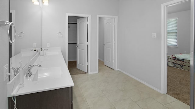 bathroom with tile patterned flooring and vanity