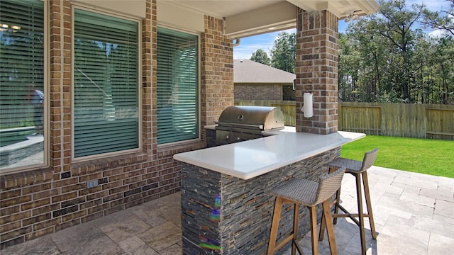 view of patio / terrace featuring a grill, exterior kitchen, and exterior bar