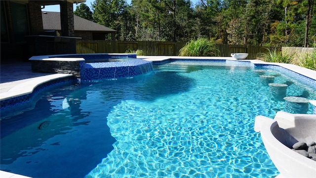 view of swimming pool featuring an in ground hot tub