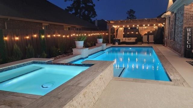 pool at twilight featuring an outdoor hangout area