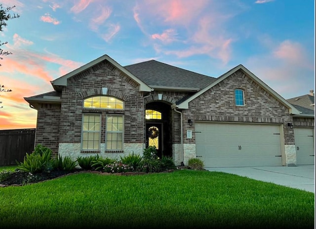 view of front facade with a lawn and a garage