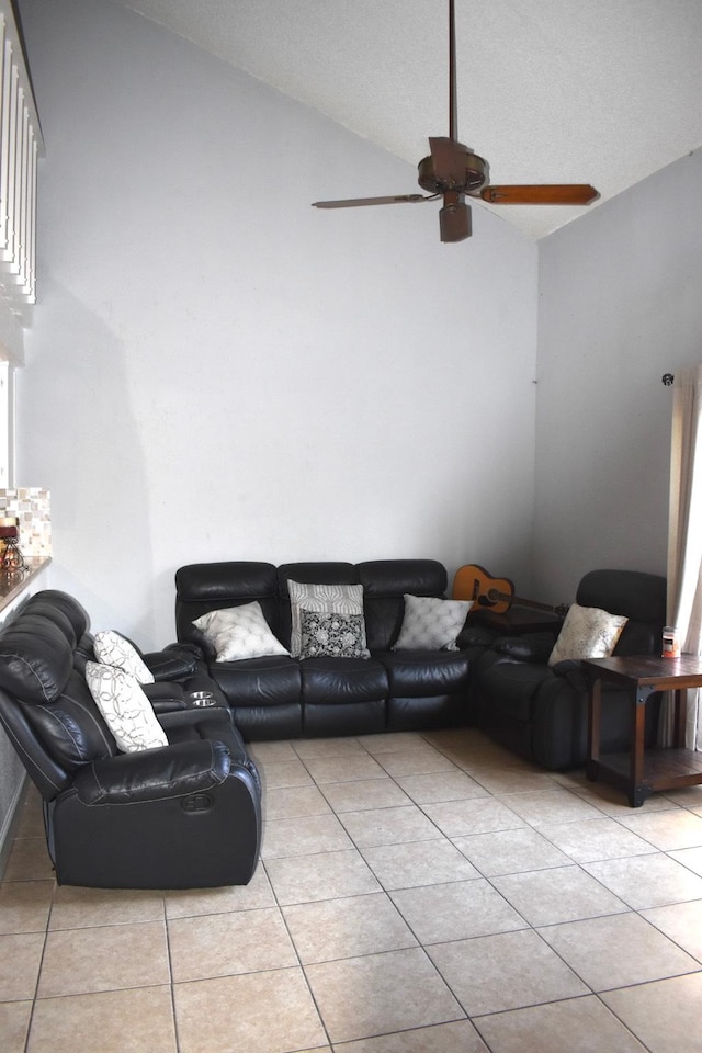 tiled living room featuring ceiling fan and lofted ceiling