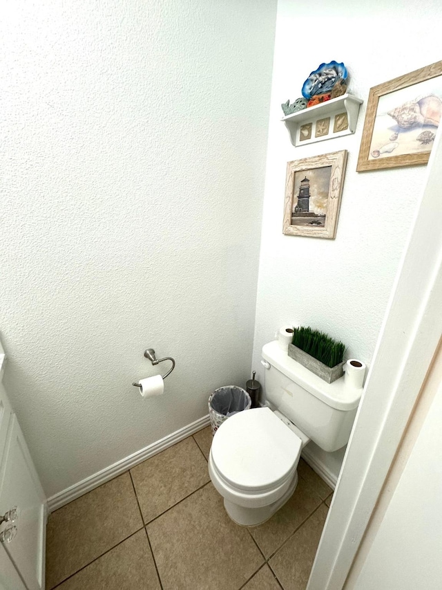 bathroom featuring tile patterned flooring and toilet