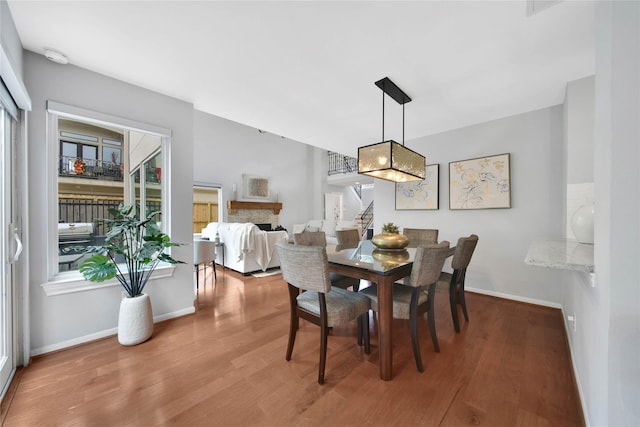 dining room with wood-type flooring and a wealth of natural light