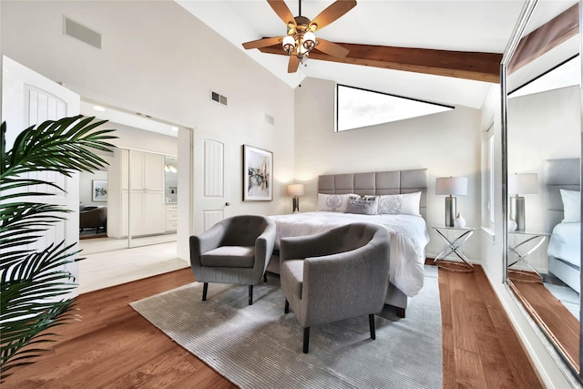 bedroom featuring vaulted ceiling with beams, ceiling fan, and wood-type flooring