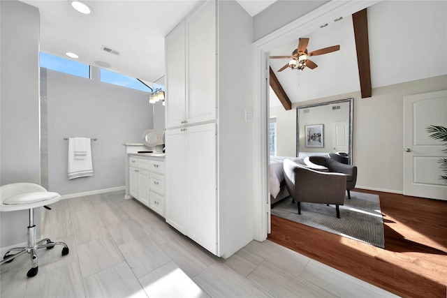 bathroom with vaulted ceiling with beams and ceiling fan