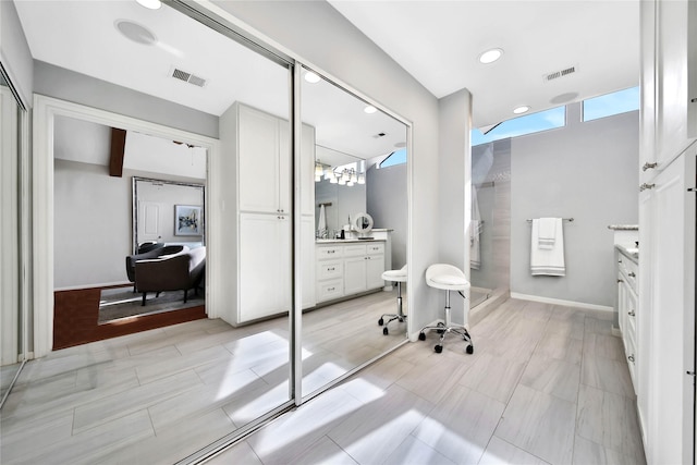 bathroom featuring vanity and a shower with door