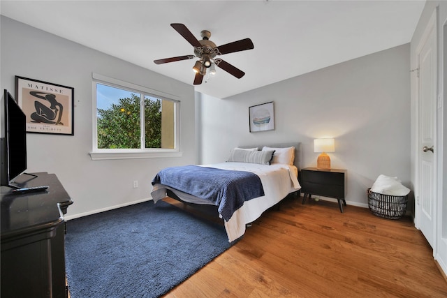 bedroom featuring hardwood / wood-style floors and ceiling fan