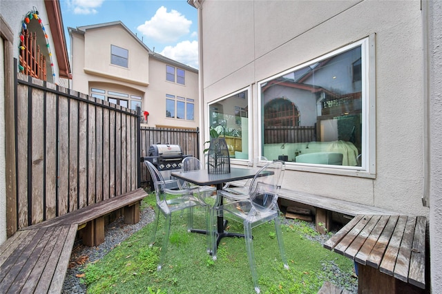 deck featuring a yard and grilling area