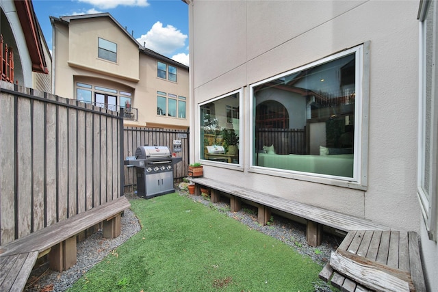 wooden terrace featuring a lawn and area for grilling