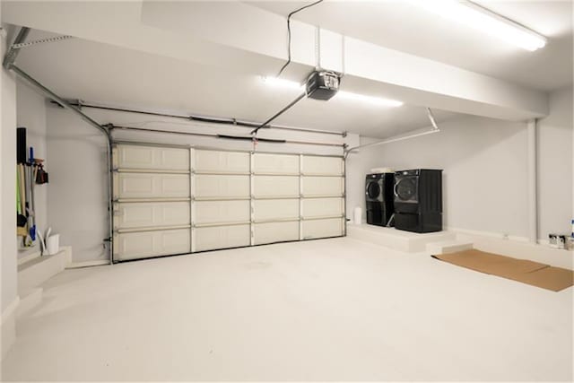 garage with washer and dryer and a garage door opener