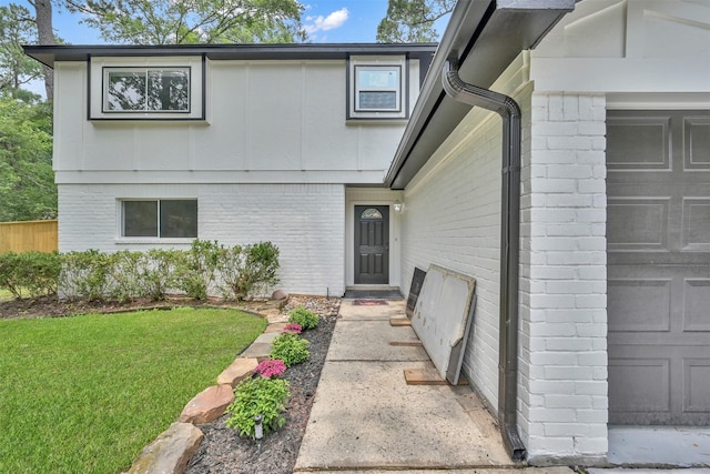 property entrance with a lawn