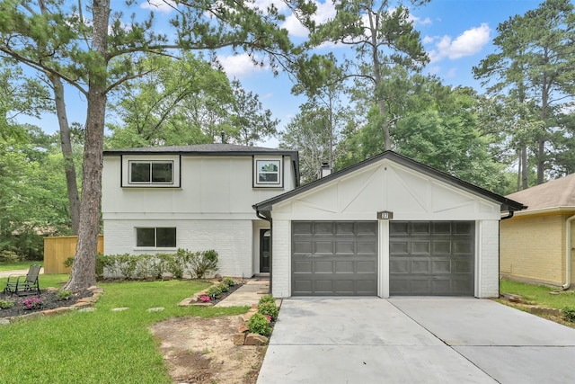 view of front of home with a garage and a front lawn