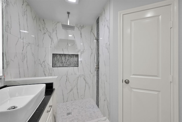 bathroom with vanity and tiled shower