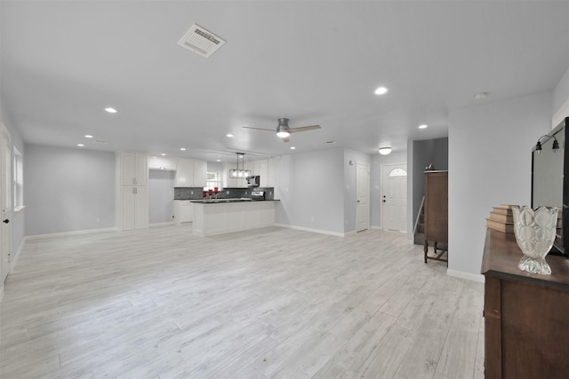 living room with light hardwood / wood-style flooring and ceiling fan