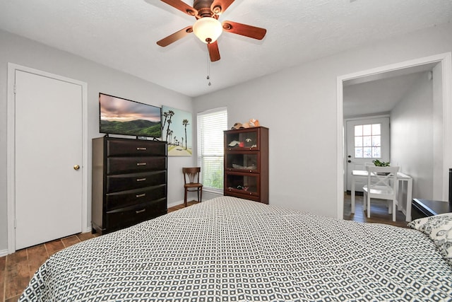 bedroom with ceiling fan and wood-type flooring