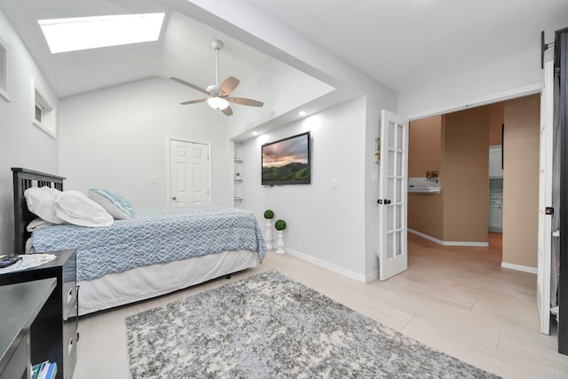 bedroom featuring ceiling fan and vaulted ceiling with skylight