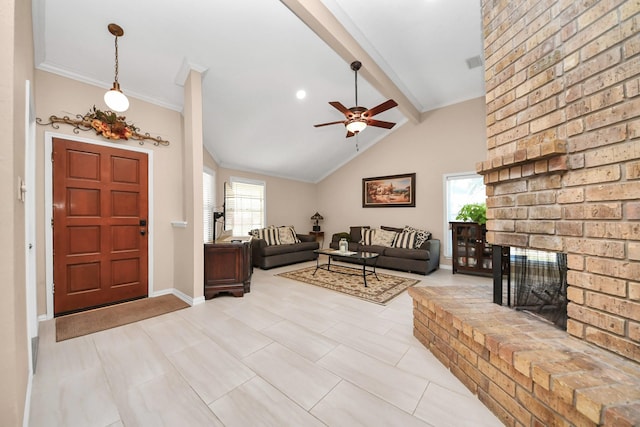 living room with a brick fireplace, lofted ceiling with beams, ceiling fan, and a healthy amount of sunlight