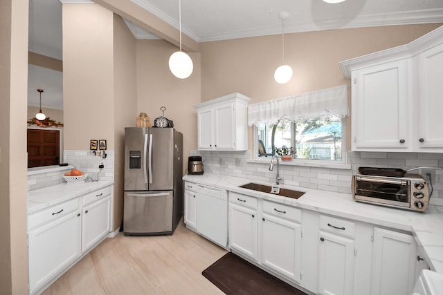 kitchen featuring stainless steel refrigerator with ice dispenser, backsplash, decorative light fixtures, white dishwasher, and sink