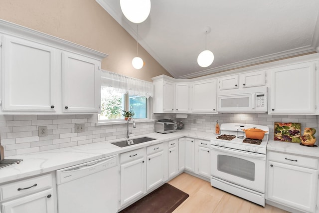 kitchen with white appliances, decorative light fixtures, white cabinetry, sink, and vaulted ceiling