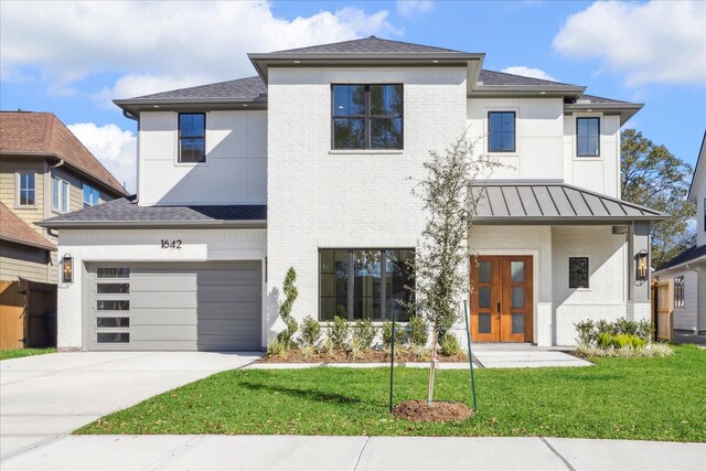 view of front of property featuring a garage and a front lawn