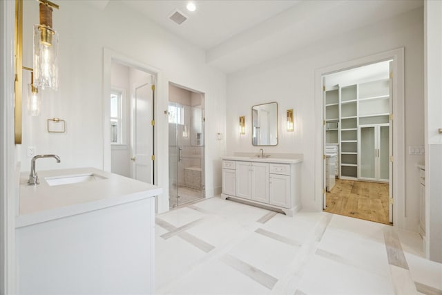 bathroom with vanity, tile patterned flooring, and a shower with door