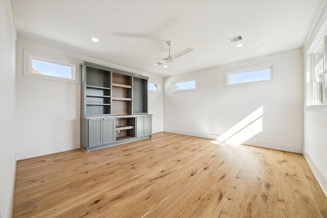 unfurnished living room with ceiling fan, plenty of natural light, and light wood-type flooring